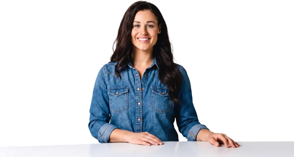 Kaitie Brinston, founder of Culture Academy, smiling with her hands resting on a table