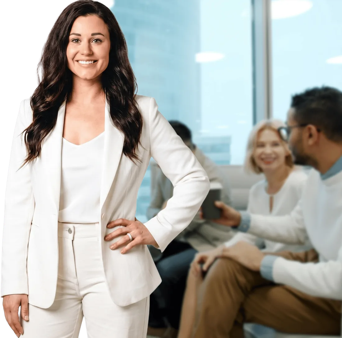 Kaitie Brinston in a cream blazer, with a team working together behind her